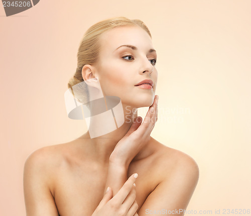 Image of woman touching her face