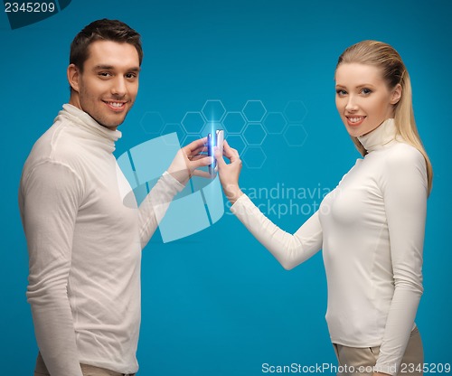 Image of man and woman with modern gadgets