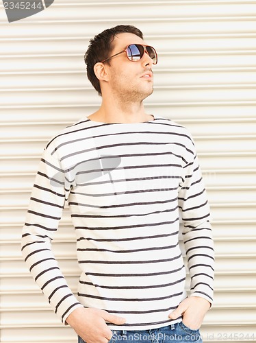 Image of handsome man in casual clothes  wearing sunglasses