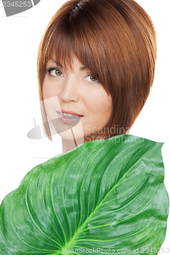 Image of woman with green leaf