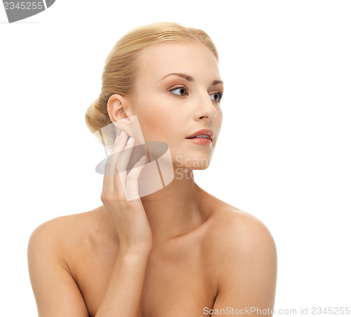 Image of woman touching her face skin