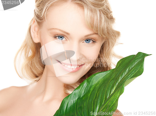 Image of woman with green leaf