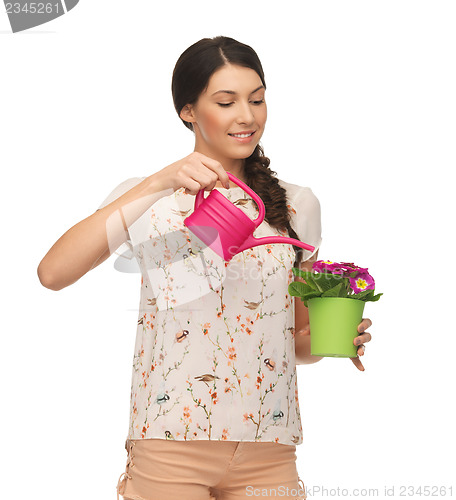 Image of housewife with flower in pot and watering can