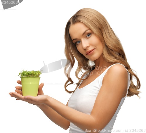 Image of woman with green grass in pot