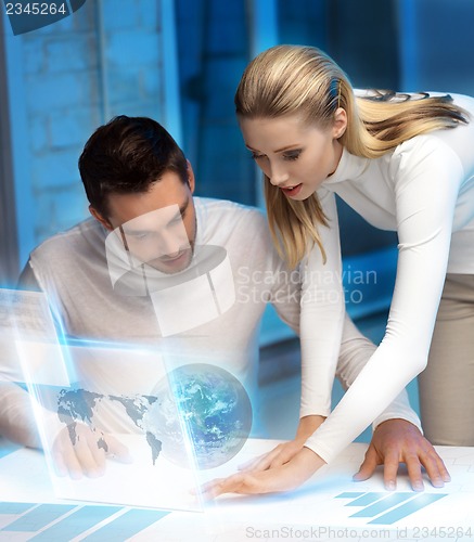 Image of man and woman working with virtual screen