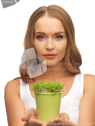 Image of woman with green grass in pot