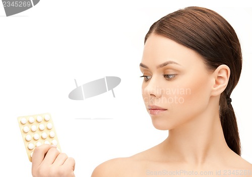 Image of young woman with pills