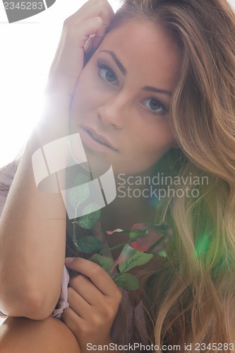 Image of beautiful woman with rose