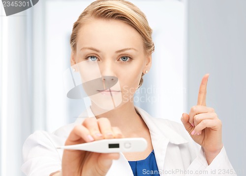 Image of attractive female doctor with thermometer