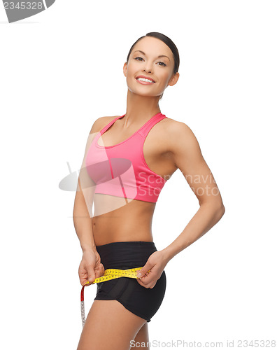 Image of sporty woman with measuring tape