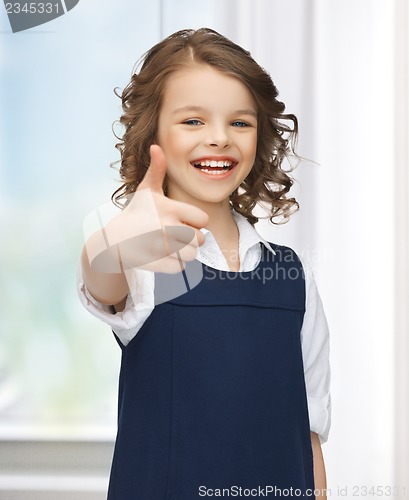 Image of pre-teen girl showing thumbs up