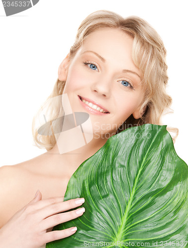 Image of woman with green leaf