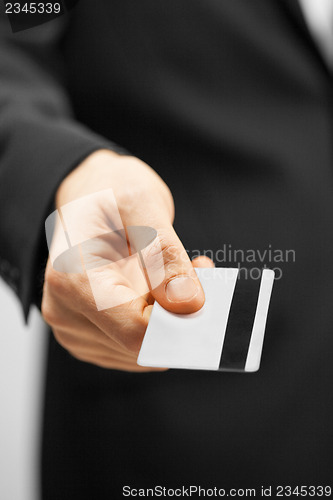 Image of man in suit holding credit card