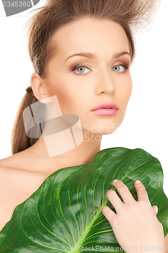 Image of woman with green leaf