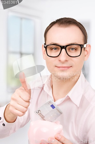 Image of businessman with piggy bank and money