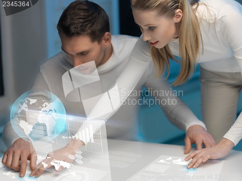 Image of man and woman working with virtual screens