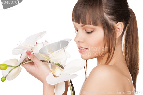 Image of lovely woman with orchid flower