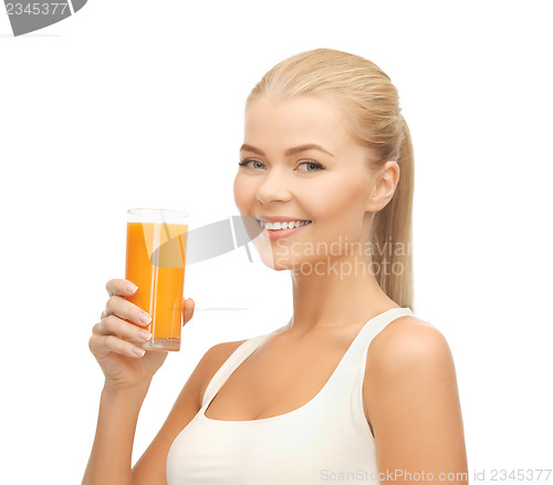 Image of woman holding glass of orange juice