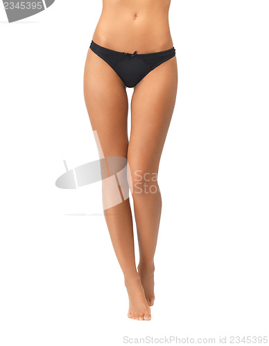 Image of female legs in black bikini panties