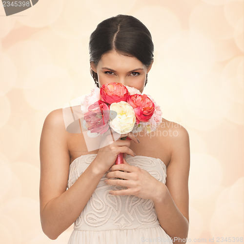 Image of woman smelling bouquet of flowers