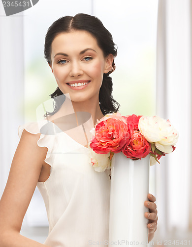 Image of woman with vase of flowers