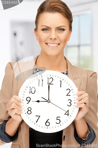 Image of woman holding big clock