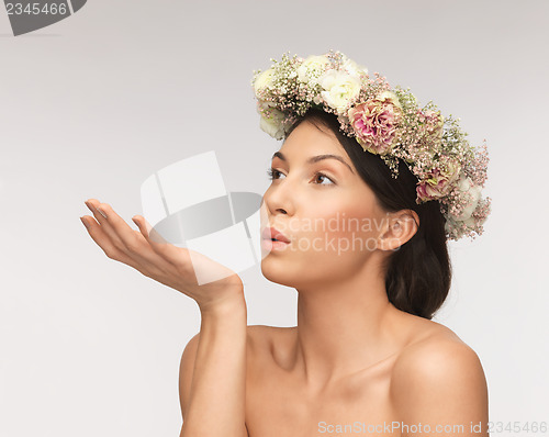 Image of woman wearing wreath of flowers