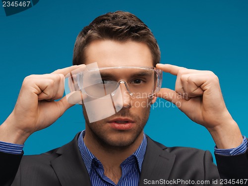 Image of businessman in protective glasses
