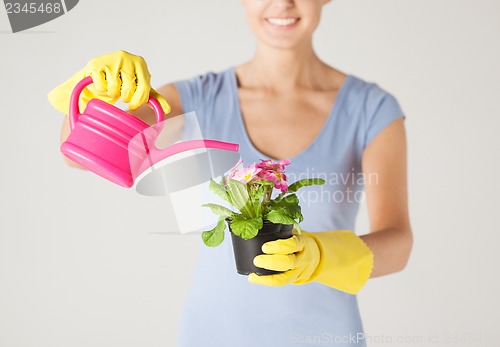 Image of woman holding pot with flower