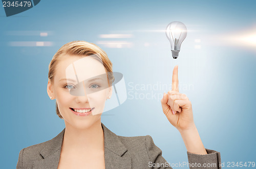 Image of woman pointing her finger at light bulb