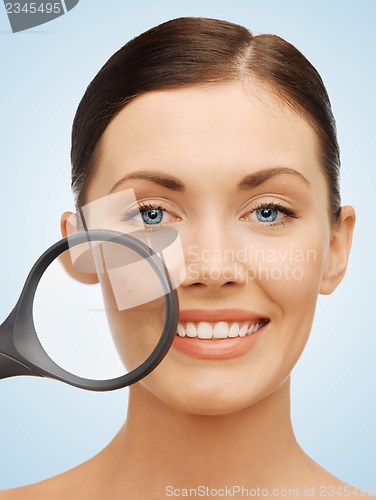 Image of woman with magnifying glass over acne