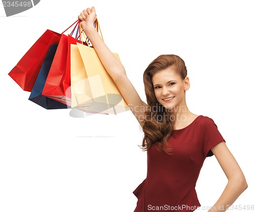 Image of teenage girl in red dress with shopping bags