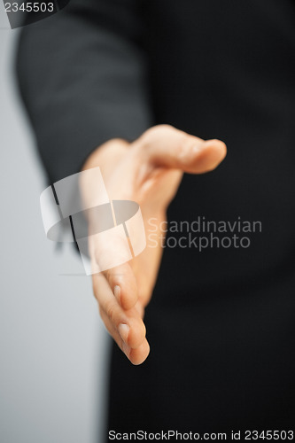 Image of man in suit with an open hand