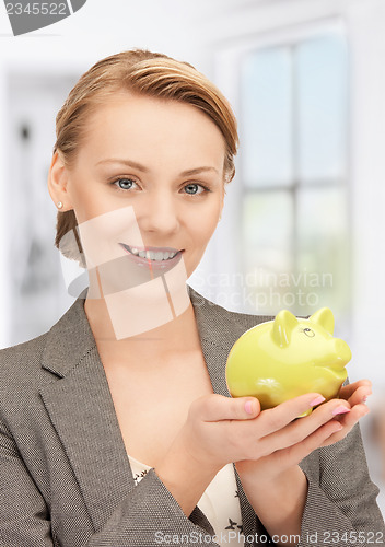 Image of lovely woman with piggy bank