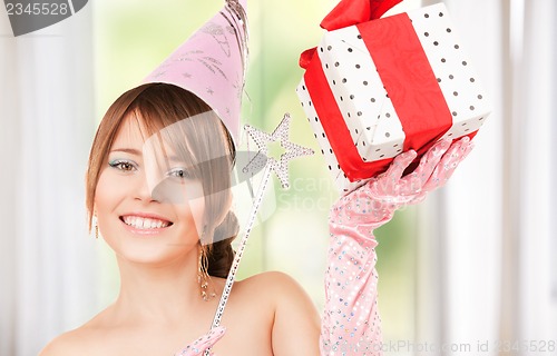 Image of teenage party girl with magic wand and gift box