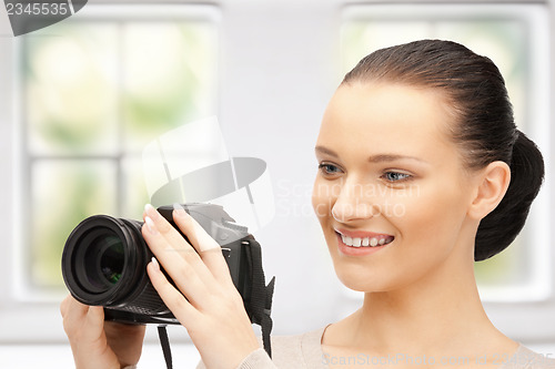 Image of teenage girl with digital camera