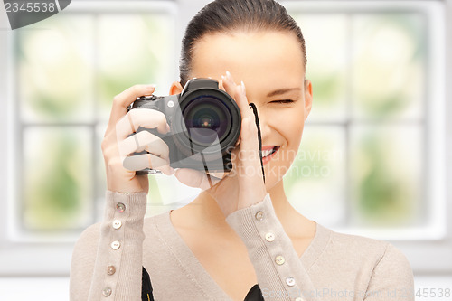 Image of teenage girl with digital camera