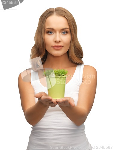 Image of woman with green grass in pot