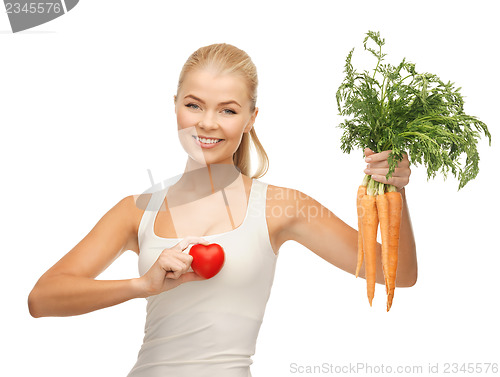 Image of woman holding heart symbol and carrots