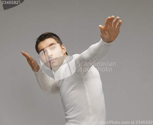 Image of man working with something imaginary