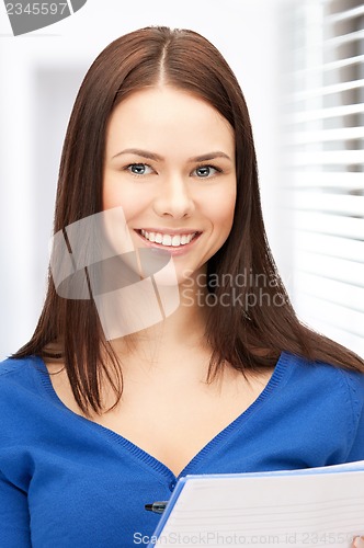 Image of happy woman with big notepad