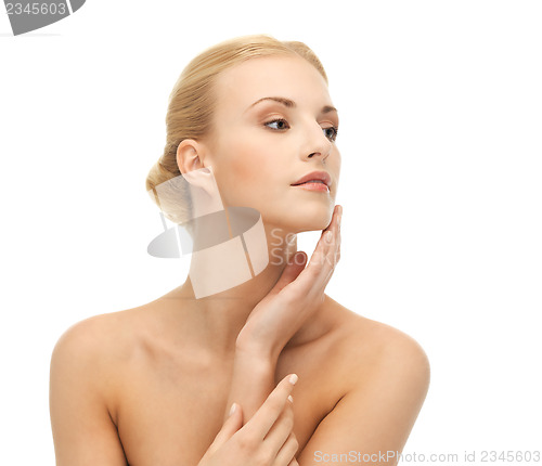 Image of woman touching her face skin