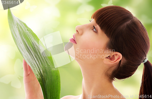 Image of woman with green leaf and butterflies