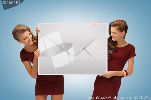Image of girls holding big envelope