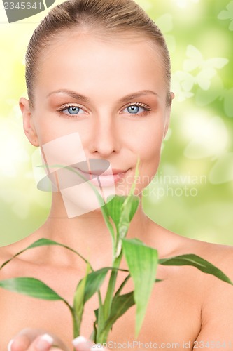 Image of woman with sprout and butterflies