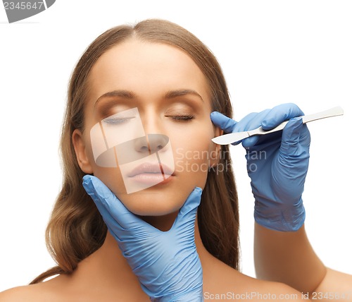 Image of woman face and beautician hands