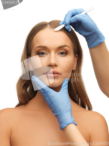 Image of woman face and beautician hands