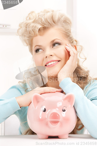 Image of lovely woman with piggy bank