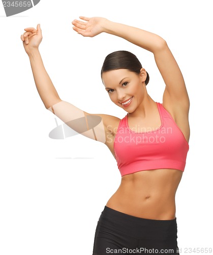 Image of beautiful sporty woman doing exercise