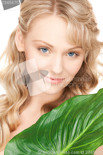 Image of woman with green leaf